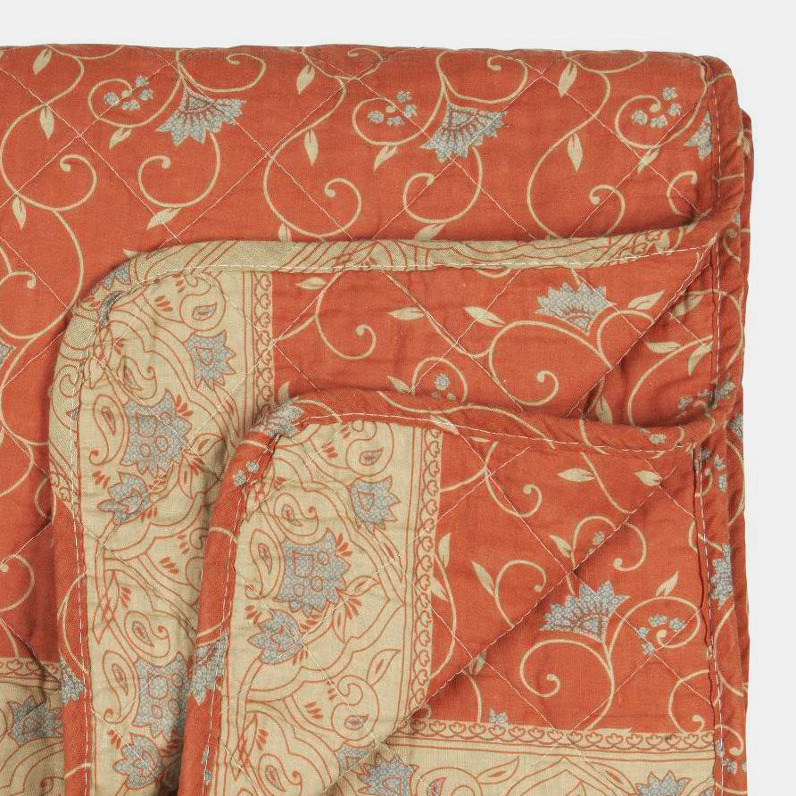 Woven quilt for bed in orange blue floral pattern in Amsterdam Netherlands