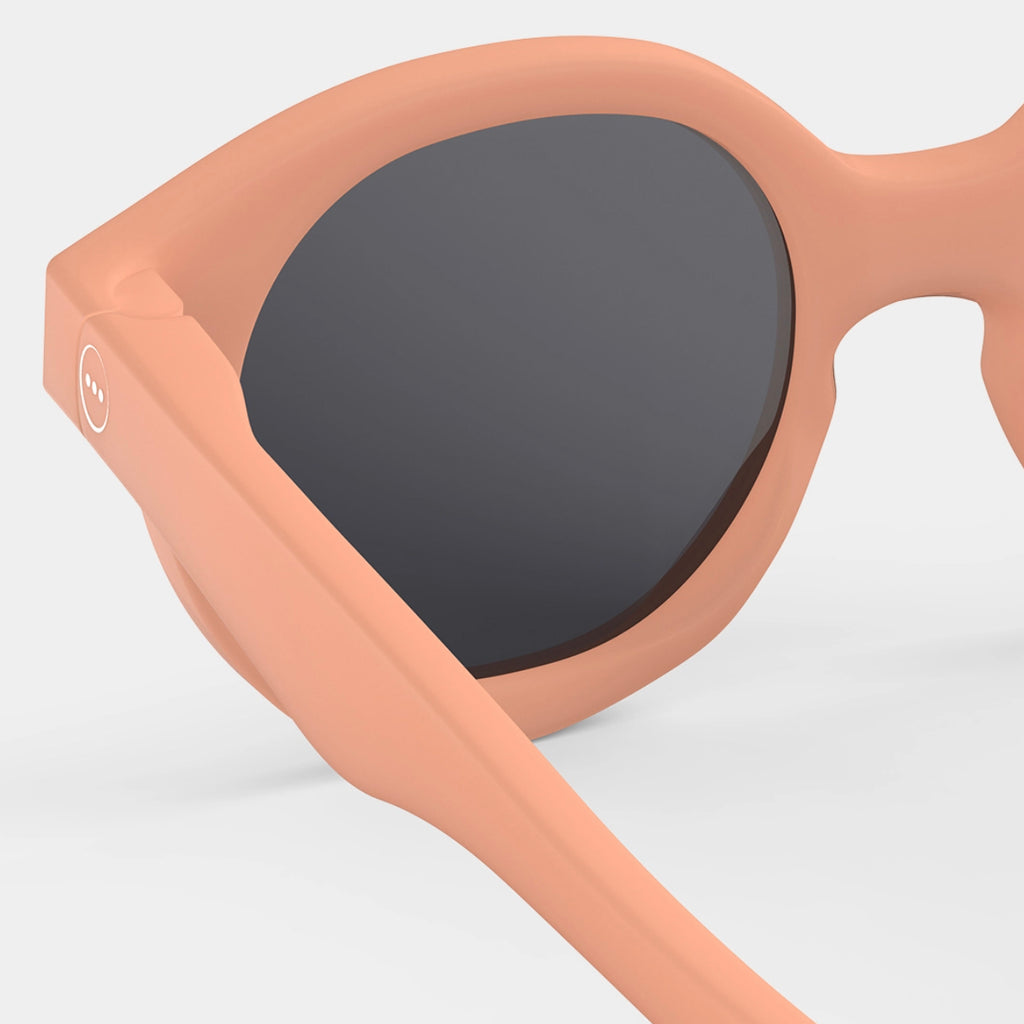 Peach and pink colored sunglasses for a child with strap by Izipizi in Amsterdam Netherlands