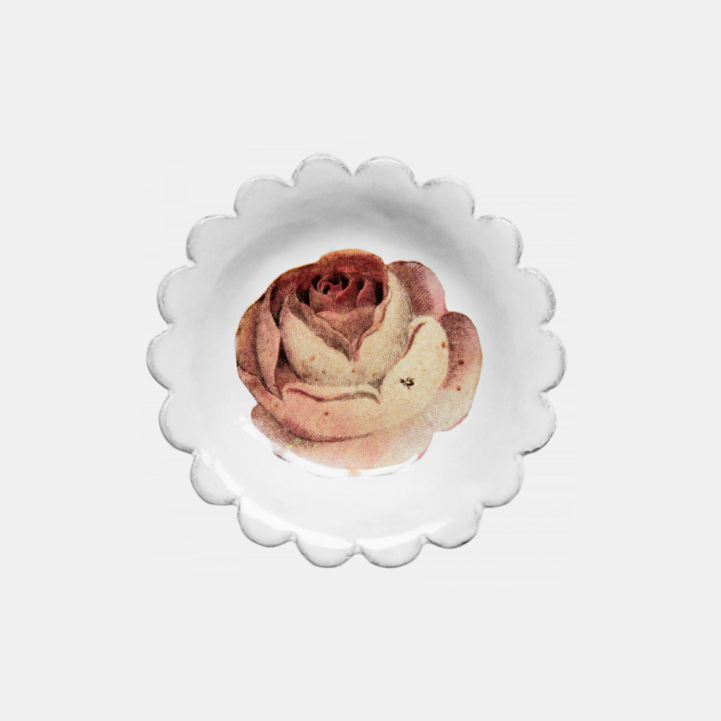 White ceramic dish with scalloped edge and pink rose
