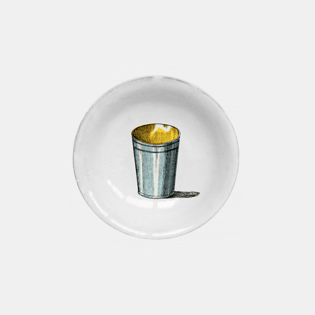 White ceramic plate dish with silver blue and yellow tin cup by Astier de Villatte in Amsterdam Nederlands