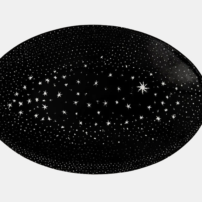 Black ceramic dish platter with white stars in constellations by John Derian close up