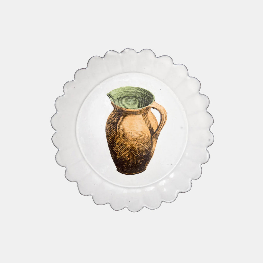 White ceramic scalloped dish plate with copper pitcher by Astier de Villatte in Amsterdam Nederlands